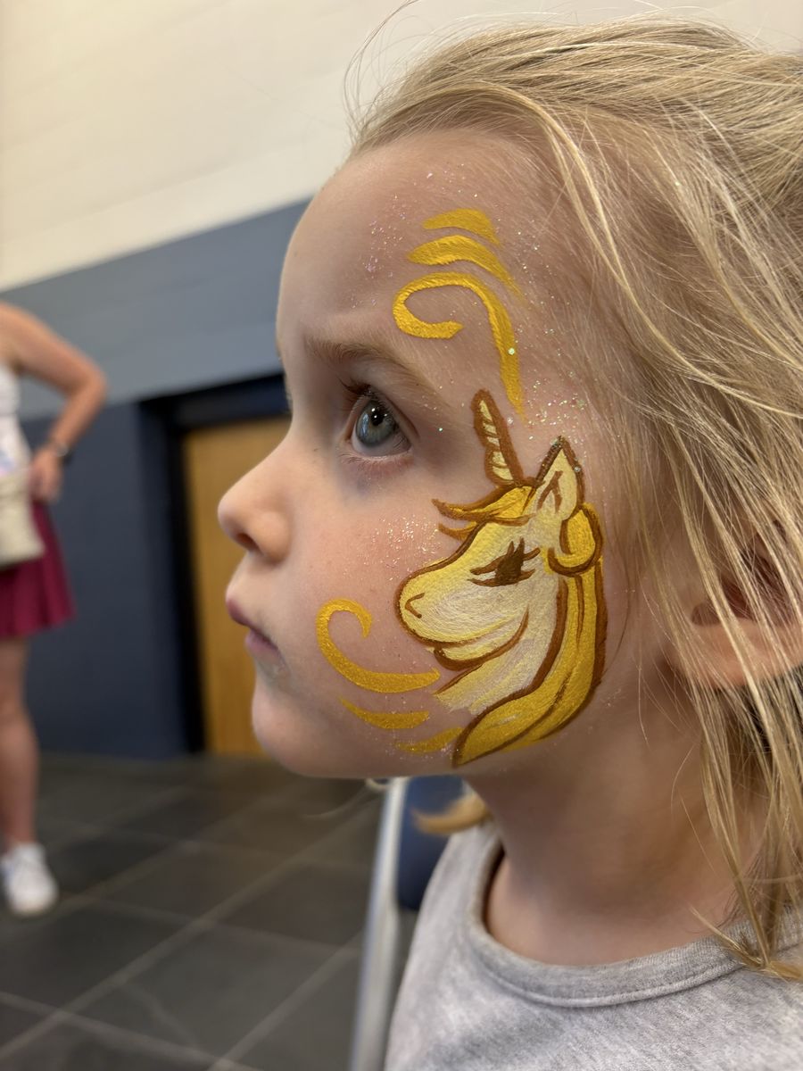 Gold and white unicorn cheek design with a flowing mane, horn and glitter accents