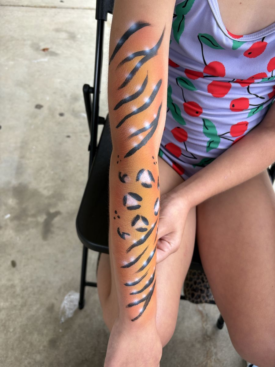 Airbrushed orange tiger-stripe full arm sleeve with black stripes and paw print detail