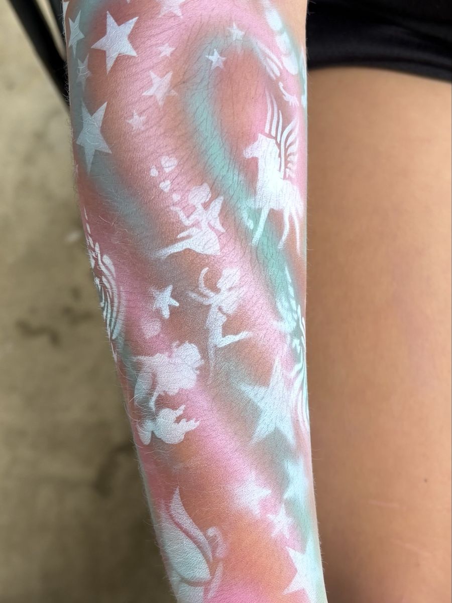 Airbrushed pastel pink and mint arm sleeve with white stars, unicorns, fairies and butterflies